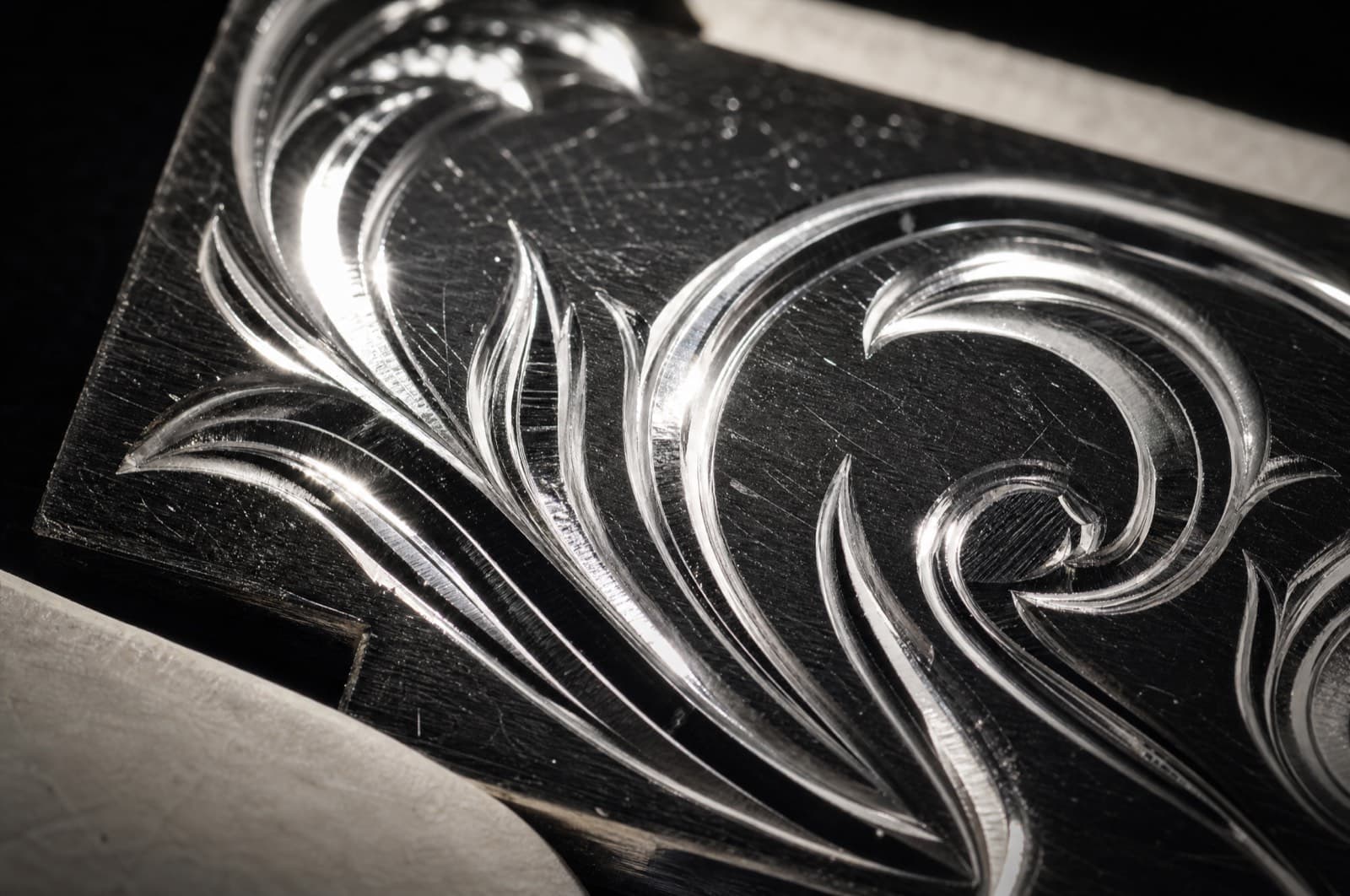 Macro of hand engraving on polished silver